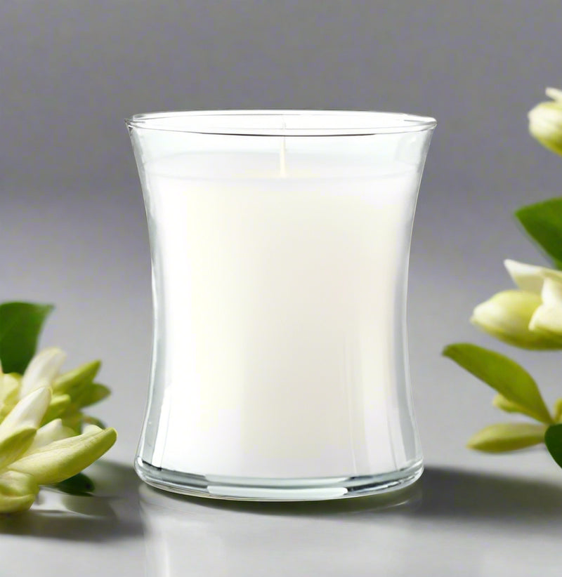 elegant Clear glass Belize candle with a white candle on a white background