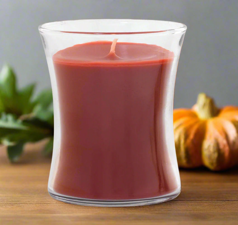 Red Christmas  candle in a clear elegant glass container on a white background
