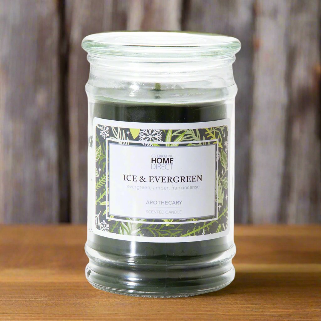 A 17 oz jar candle with a label reading 'HOME ICE & EVERGREEN', suggesting a winter fragrance.