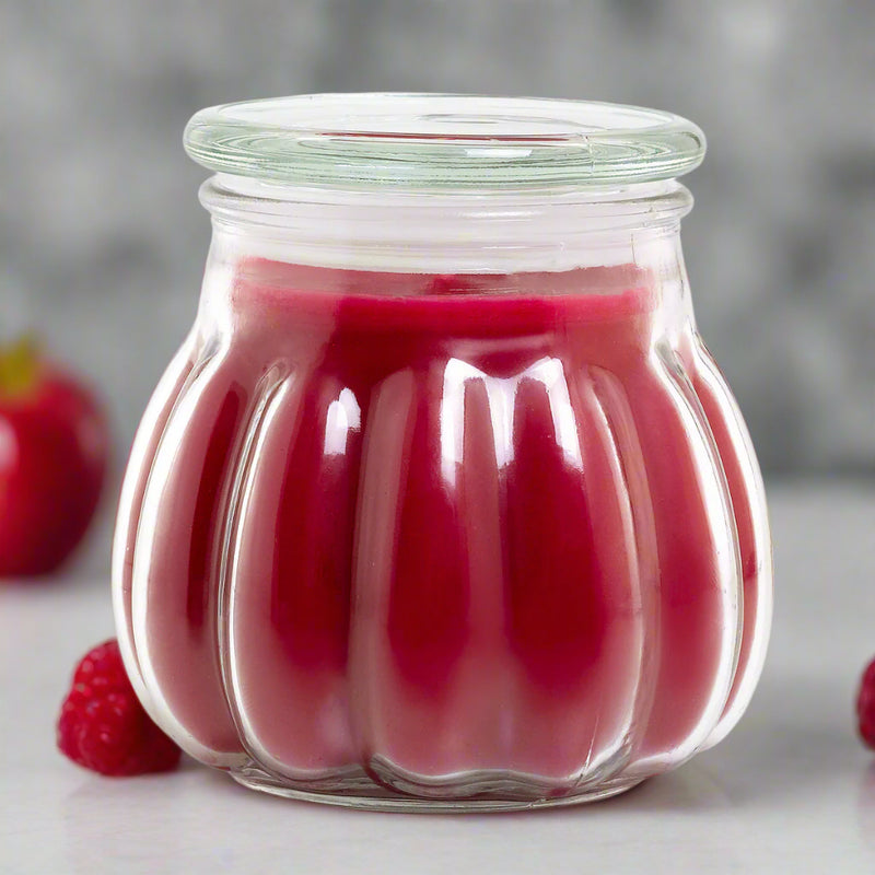 A Contempo jar candle with a red hue, possibly infused with pomegranate and berries