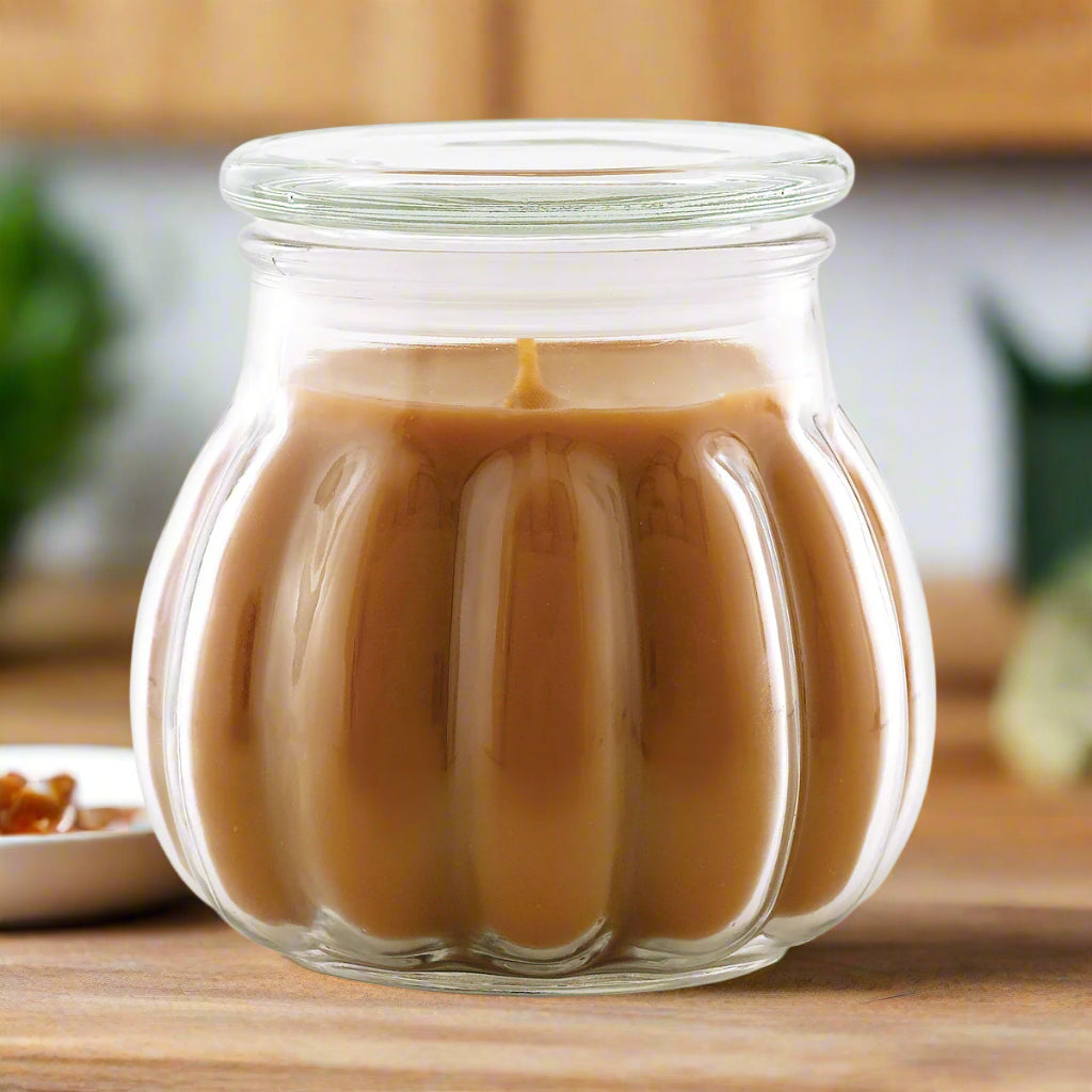A texture salted caramel jar candle with a brown color scent, placed on a white background.